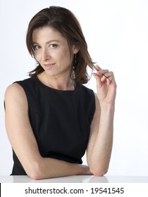 Portrait On White Background Of A Forty Years Old Woman In Studio