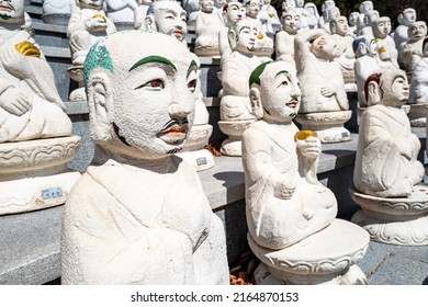 Portrait of one of the 500 Buddha’s Disciples white statues in Bomunsa Temple on the island of Seongmodo, Ganghwa, Incheon, South Korea.