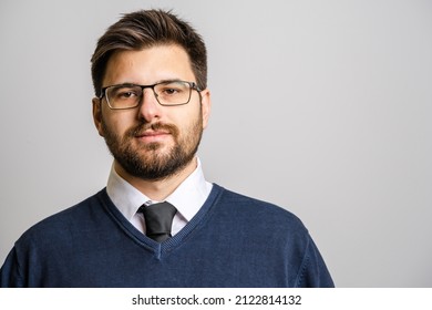 Portrait Of One Adult Caucasian Man 30 Years Old With Beard And Eyeglasses Looking To The Camera In Front Of White Wall Background Wearing Sweater Young Businessman Success Concept Copy Space