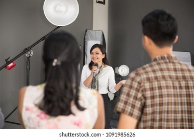 Portrait Of One Person Standing In The Front While Explain Something About Photography