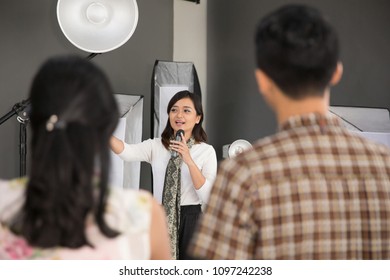 Portrait Of One Person Standing In The Front While Explain Something About Photography