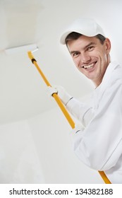 Portrait Of One Smiling Male House Painter Worker With Painting Roller