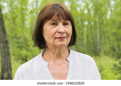 Portrait Of One Woman 60 Years Old In A Summer Forest.