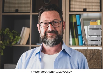 Portrait of one young and happy cheerful man smiling looking at the camera having fun. Headshot of male person working at home in the office.
