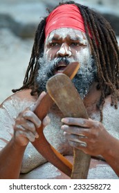 Portrait Of One Yugambeh Aboriginal Man Playing Music With Boomerangs And Sing During Aboriginal Culture Show In Queensland, Australia.