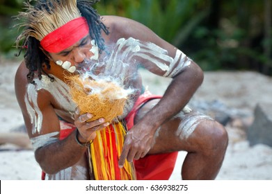 Portrait of one Yugambeh Aboriginal warrior demonstrate fire making craft during Aboriginal culture show in Queensland, Australia. - Powered by Shutterstock