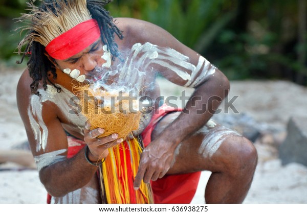 Portrait of one Yugambeh Aboriginal warrior
demonstrate fire making craft during Aboriginal culture show in
Queensland, Australia.