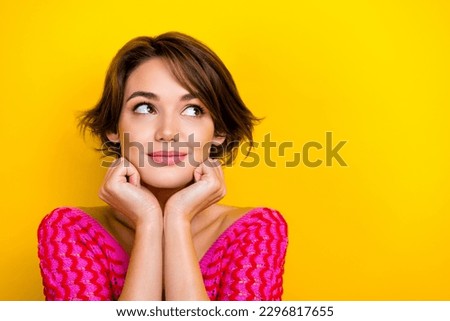 Portrait of optimistic pleasant dreamy woman short haircut wear pink knit top look empty space isolated on yellow color background