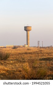 Portrait Orientation Of A Typical Winter Scene In Rural South Africa Of A Municipal Water Reservoir And Communication Tower And Hazy Air Pollution  