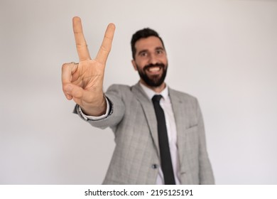 Portrait Of Outgoing Man With Beard. Male In Suit Gesturing, Showing Victory Sign. Portrait, Emotion Concept