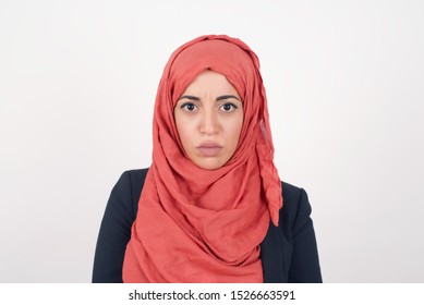 Portrait of outraged young muslim woman with oval face, frowning her eyebrows being displeased with something. Scowling pretty female isolated over white - Shutterstock ID 1526663591