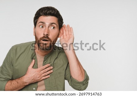 Portrait, overhearing and hand gesture for eavesdropping with a man listening in studio on white background. Emoji, communication and secret with a male person in shocked about news, copy space