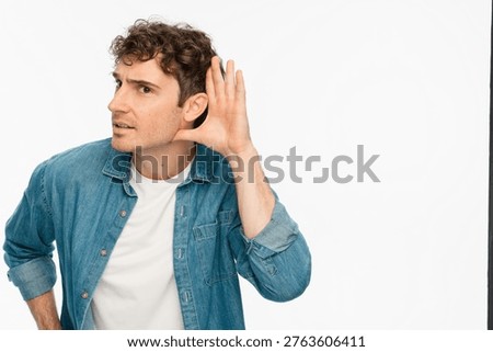Portrait, overhearing and hand gesture for eavesdropping with a man listening in studio on white background. Emoji, communication and secret with a male person in shocked about news, copy space