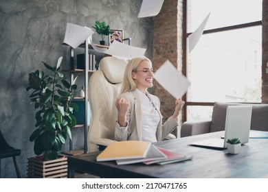 Portrait Of Overjoyed Business Lady Sit Chair Throw Papers Raise Fists Celebrate Attainment Achievement Workstation Indoors