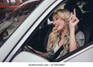 Portrait of overjoyed funky girl have good mood drive new car listen favorite radio station