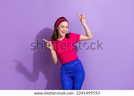 Portrait of overjoyed positive lady point fingers enjoy clubbing dancing isolated on purple color background