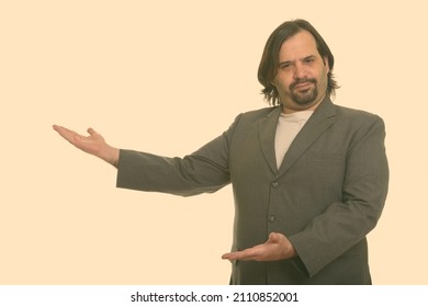 Portrait of overweight Caucasian man against plain studio background - Shutterstock ID 2110852001