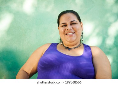 Portrait Of Overweight Hispanic Woman Looking At Camera And Smiling