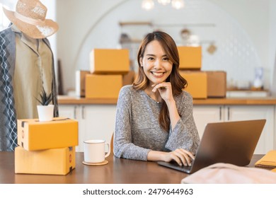 Portrait of owner asian woman freelancer sme business online shopping working checklist order and packing product, cardboard box, E-commerce, marketing, entrepreneur, Business online, startup concept - Powered by Shutterstock