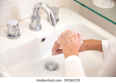 A portrait of a pair of hands, washing with soap under running water, woman hands - Shutterstock ID 292365725
