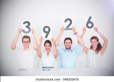 Portrait Of Panel Judges Holding Score Signs In Office