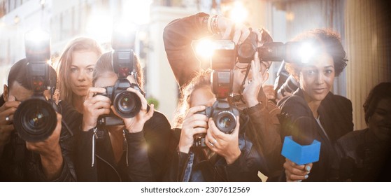 Portrait of paparazzi in a row with cameras and microphone - Powered by Shutterstock