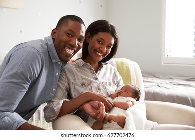 Portrait Of Parents Home From Hospital With Newborn Baby