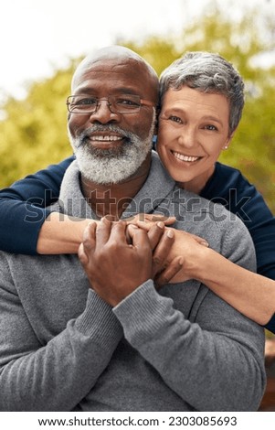 Portrait, park or senior couple with hug, interracial or romantic with bonding, marriage or relationship. Face, mature black man or elderly woman embrace, retirement or partners with romance or love