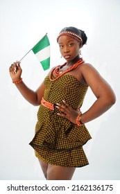 Portrait of patriotic young Nigerian woman dressed in Igbo traditional attire