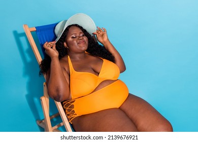 Portrait Of Peaceful Curvy Lady Sit Sun Bathing Closed Eyes Enjoy Love Herself No Negative Attitude Fat Shaming Isolated On Blue Color Background.