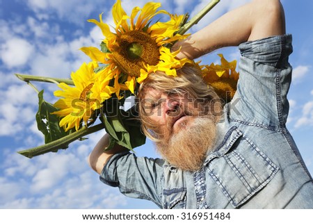 portrait of peasant in a field of sunflowers in summer day