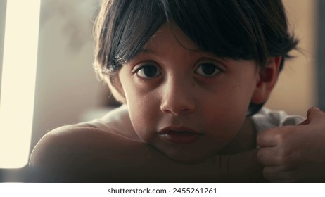 Portrait of pensive little boy gazing in thoughtful daydream, close-up face of 5 year old caucasian boy, lost in thought - Powered by Shutterstock