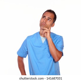 Portrait Of A Pensive Male Nurse With Hand On Chin While Standing On Isolated Background- Copyspace