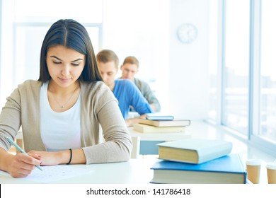 Portrait Of Pensive Student Carrying Out Test At Lesson