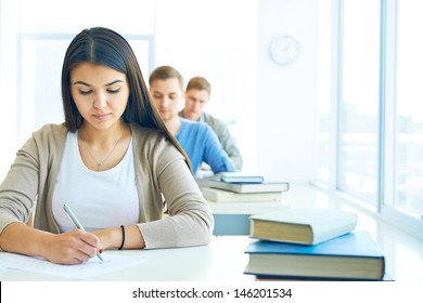 Portrait Of Pensive Student Carrying Out Test At Lesson