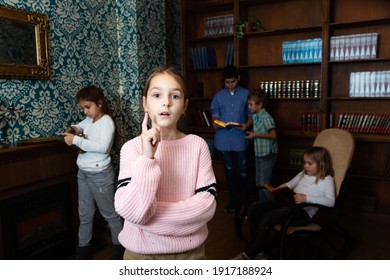 Portrait Of Pensive Tween Girl Solving Riddles In Quest Room, Pointing With Her Forefinger. Concept Of Found Solution