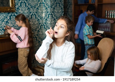 Portrait Of Pensive Tween Girl Solving Riddles In Quest Room, Pointing With Her Forefinger. Concept Of Found Solution