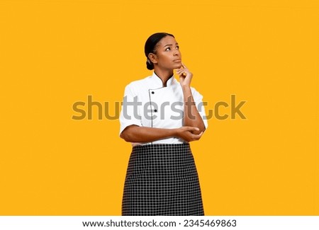 Portrait Of Pensive Young Black Chef Woman Looking At Copy Space And Touching Chin, African American Female Cook In Uniform Thinking About Interesting Offer, Standing Isolated On Yellow Background