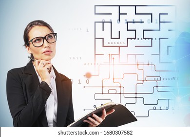 Portrait Of Pensive Young Businesswoman In Glasses Holding Notebook Near Abstract Digital Maze. Concept Of Technology And Problem Solving. Toned Blurry Image Double Exposure