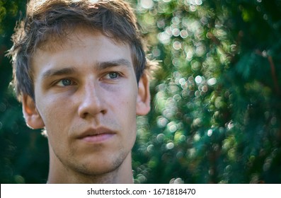 Portrait Of A Pensive Young Man Looking Off Into The Distance With A Serious Look On His Tense Face.