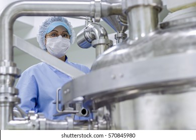 Portrait of Pharmaceutical Worker. Female Science Researcher in Protective Uniform. Female Worker Wearing Protective Clothing in Pharmaceutical Plant. Biomedical and Pharmaceutical Research.