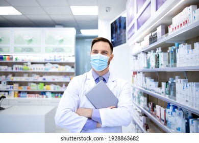 Portrait Of Pharmacist In Protection Mask Holding Tablet Computer And Standing In Pharmacy Shop.