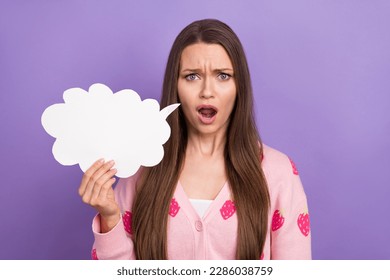 Portrait photo of dissatisfied unhappy girl brown hair stressed hold paper phrase chatterbox bad news confused isolated on violet color background