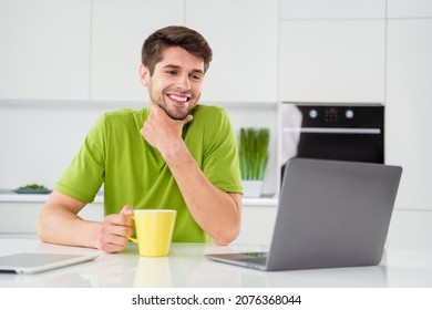 Portrait photo man using laptop sitting on kitchen drinking coffee working remotely got idea - Powered by Shutterstock