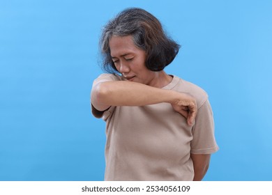 Portrait photo of mature asian woman unwell sick symptom corona virus, coughing. Isolated on blue background - Powered by Shutterstock