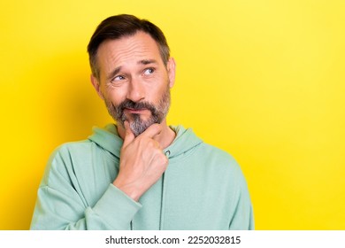 Portrait photo of old retired middle mature age man touch chin pouted lips look empty space choose product isolated on yellow color background - Powered by Shutterstock