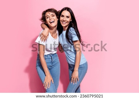 Portrait photo of two laughing carefree girls best friends hugs support trust relationships family isolated on pink color background