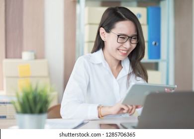 Portrait photo of young Asian business woman feeling happy after receiving product order confirmation from customer by e-mail. - Shutterstock ID 1285706365