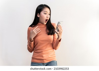 Portrait Photo Of Young Beautiful Asian Woman Feeling Happy Or Surprise Shock And Looking At Smart Phone On White Background Can Use For Advertising Or Product Presenting Concept.