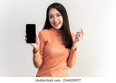 Portrait Photo Of Young Beautiful Asian Woman Feeling Happy Or Surprise Shock And Holding Smart Phone With Black Empty Screen On White Background Can Use For Advertising Or Product Presenting Concept.